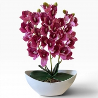 Artificial orchid Cymbidium in a vase - a realistic decorative composition for the interior