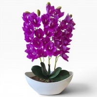 Artificial orchid Cymbidium in a vase - a realistic decorative composition for the interior